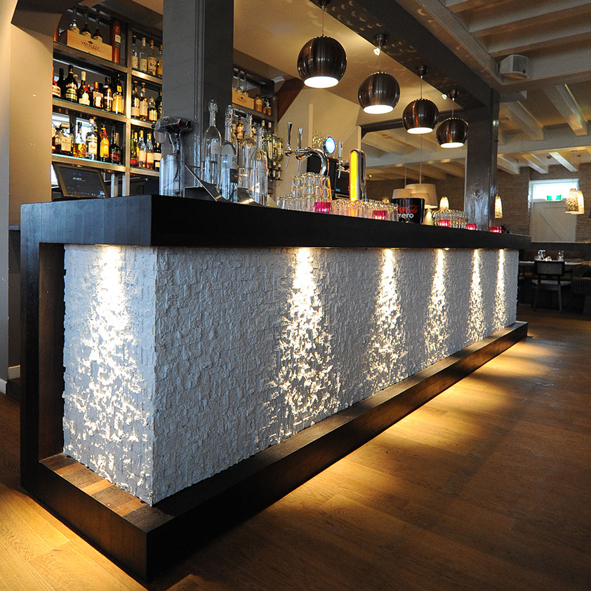 bar with white stone cube design on exterior and wooden framing
