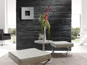gray stone wall panel with two white cushion chairs in front of it