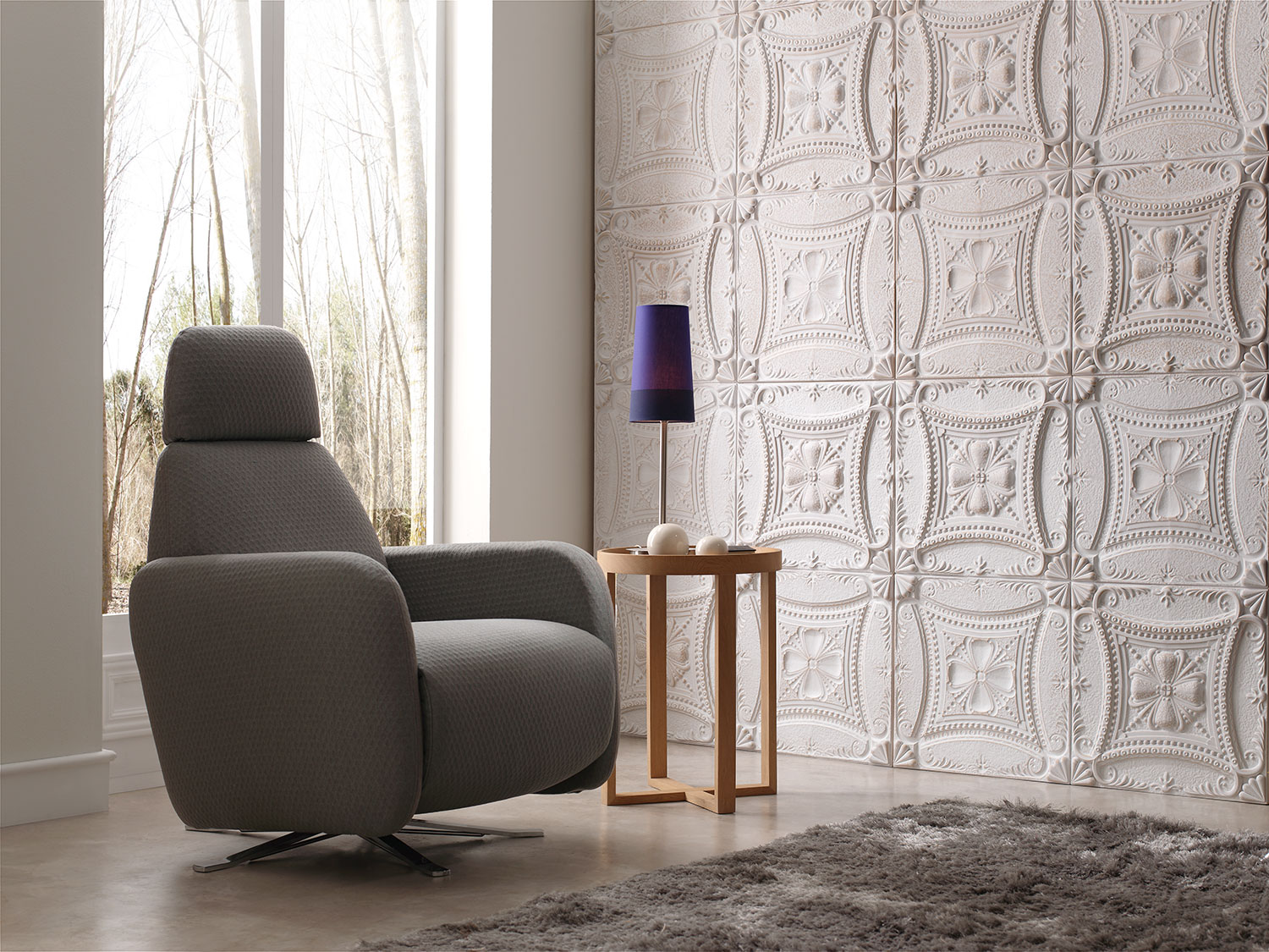 panel piedra decorative wall next to grey chair and wooden circular side table