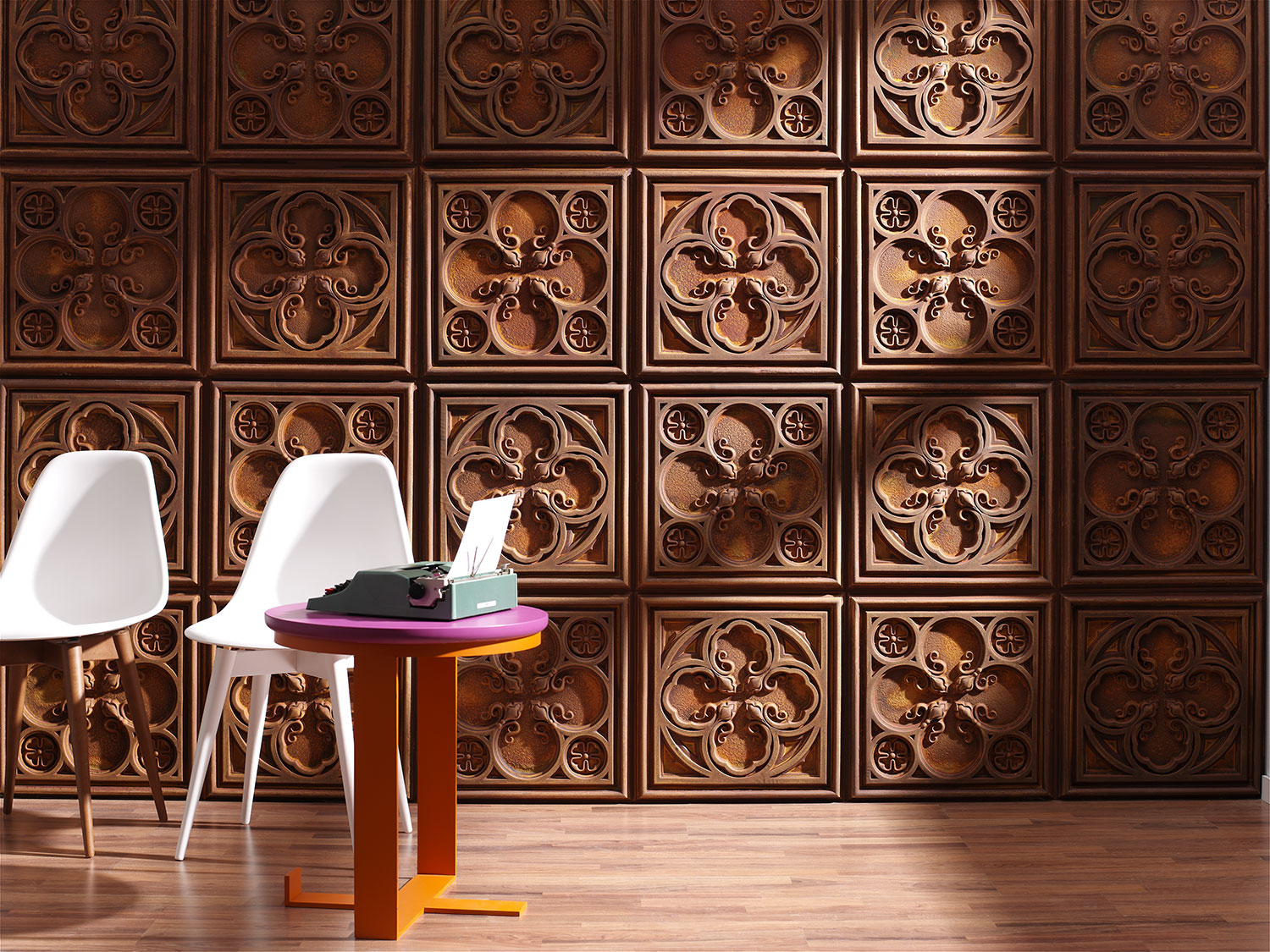 white chairs and desk with typewriter against a carved wooden panel wall