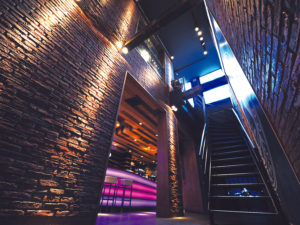 restaurant stairwell with historic brick panels