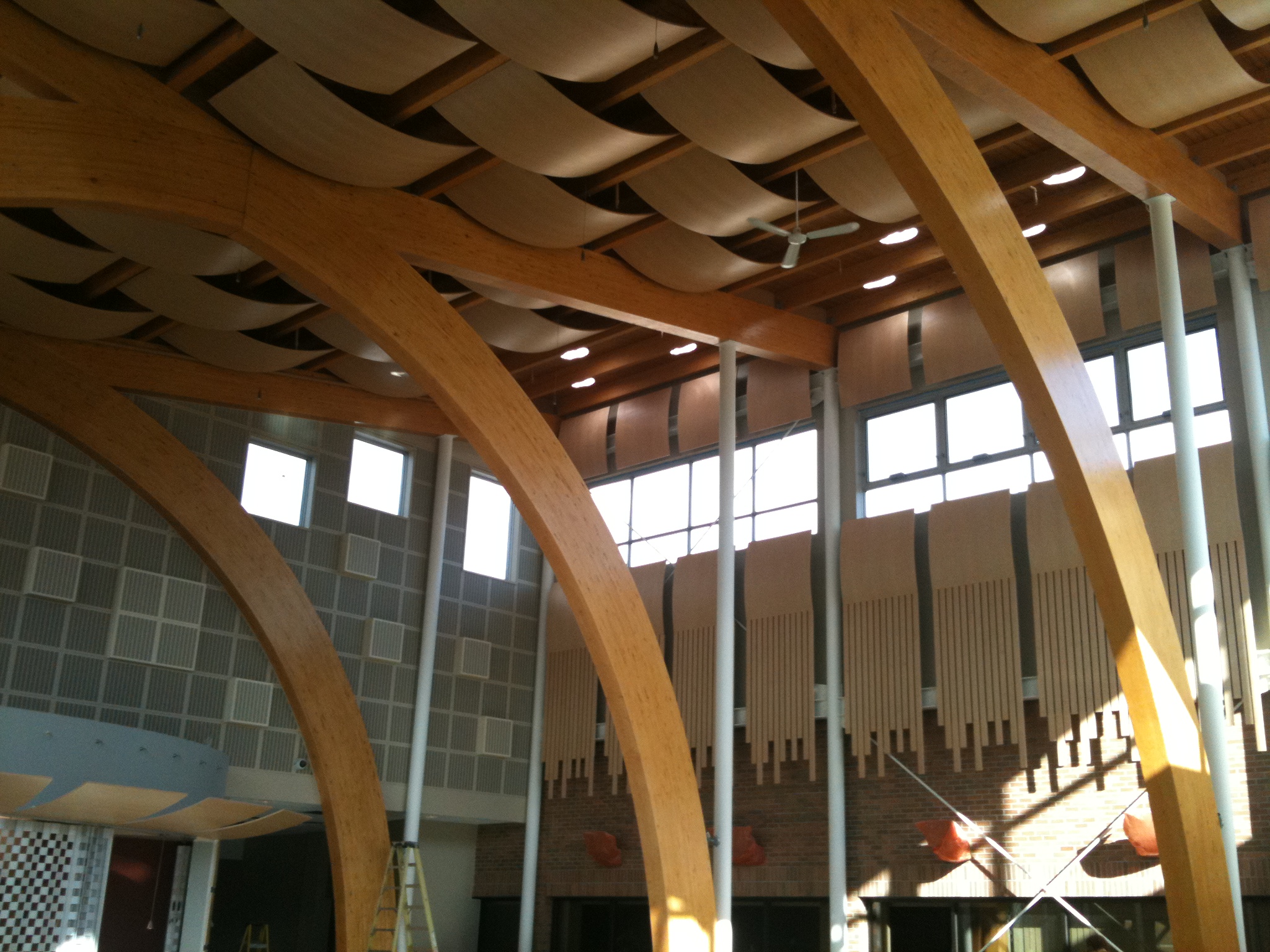 room with wooden arches up to a wave textured wooden ceiling