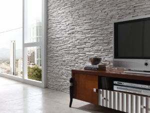 grey stone wall next to window behind wooden television table