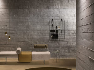 tabla grey wall with wire frame hanging from it and seating in front of it