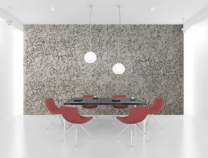 table with red chairs around it, grey and black textured wall behind it