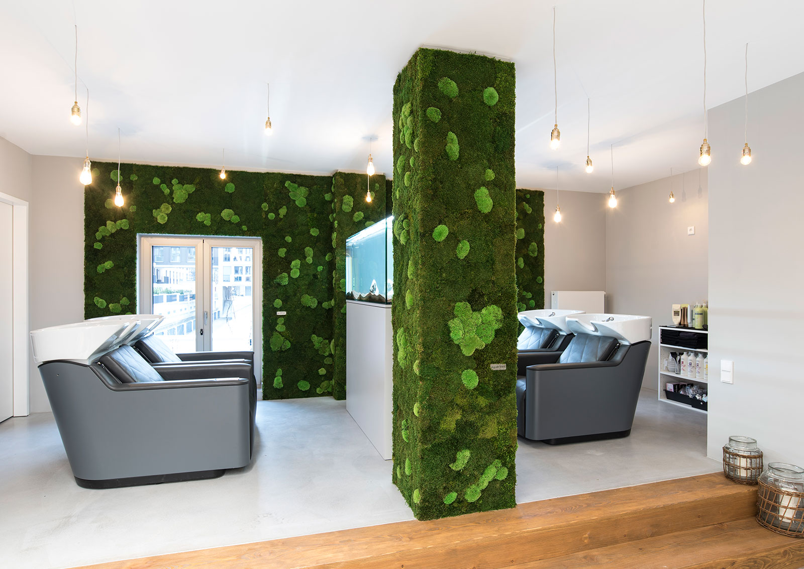 hair salon room with green moss wall and green moss pole on the middle of the room