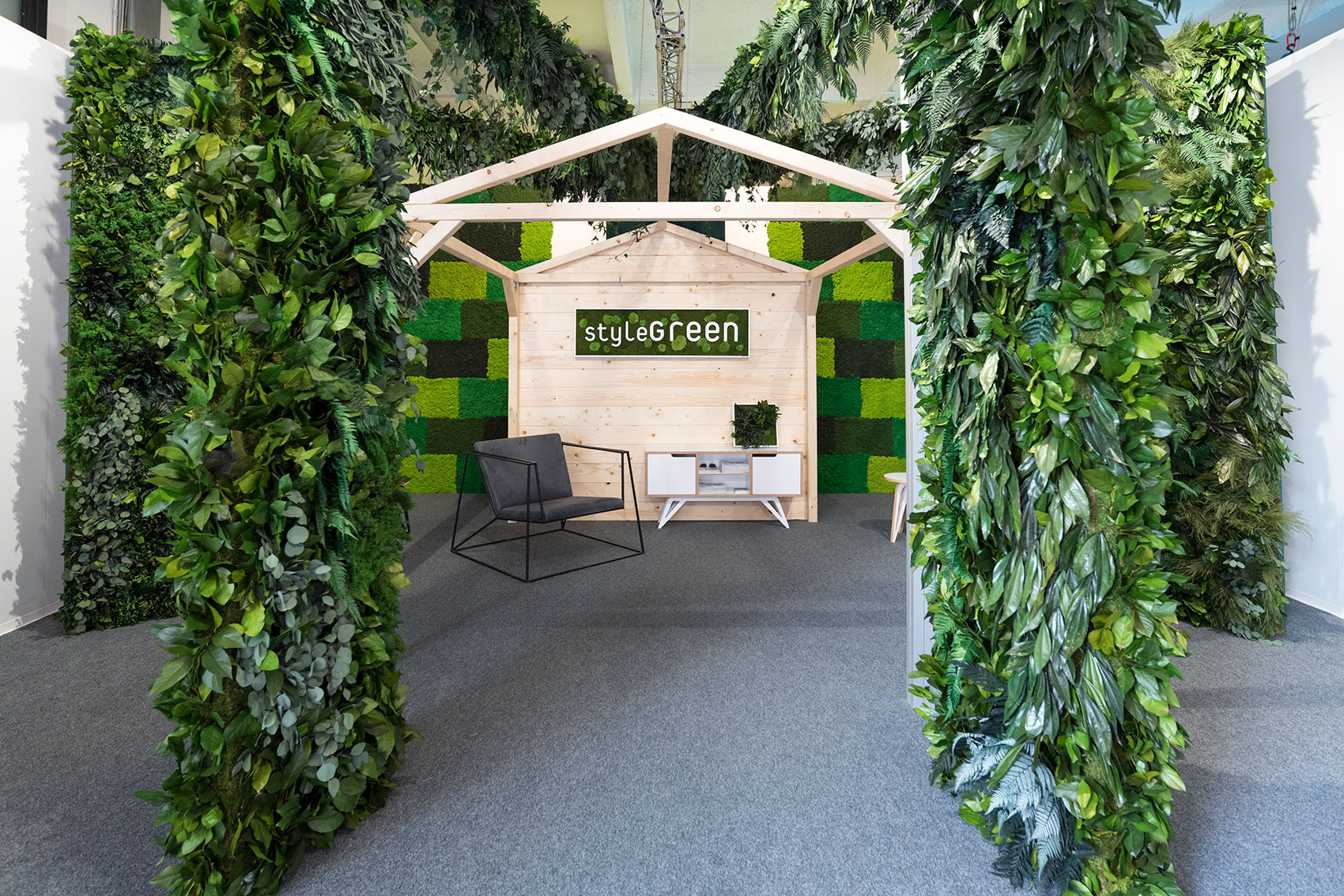 wall panels of greenery surrounding a wooden canopy