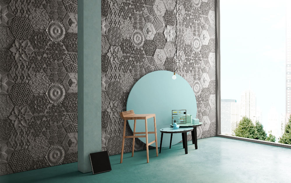 geometric grey tile walls in fron of a wooden chair and blue side tables